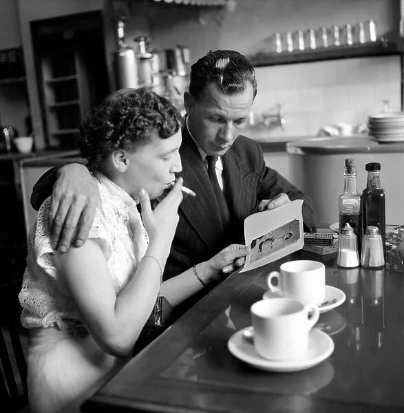 Food: Eating out: Couple in cafe in the West End of London. August 1953 D5148-001