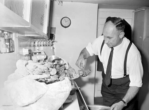 Food. Landlord of the London Inn Watchet Mr. Jim Stephens prepares the pigs trotters for