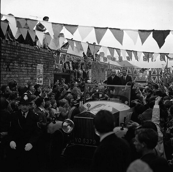 Football brothers Jack and Bobby Charlton are mobbed by crowds after leaving their