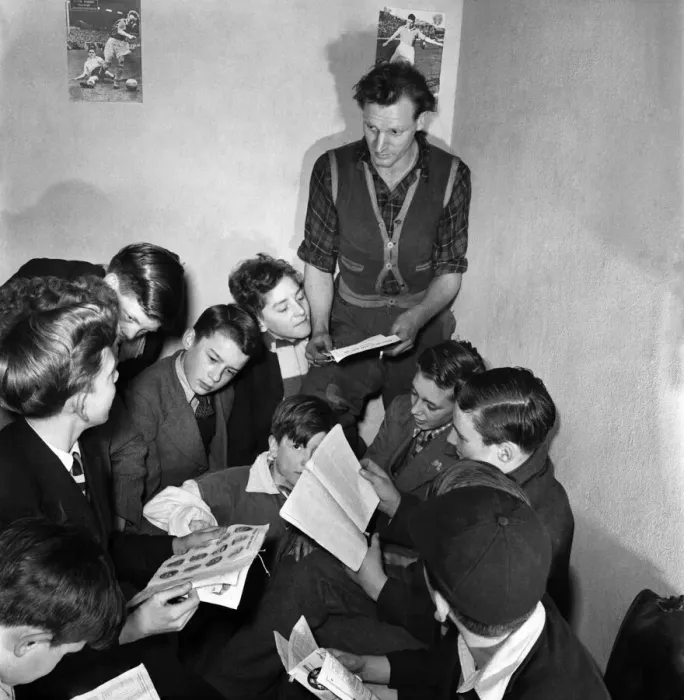 Framed Print : A football coach who runs a junior football club at Windsor with his group of players