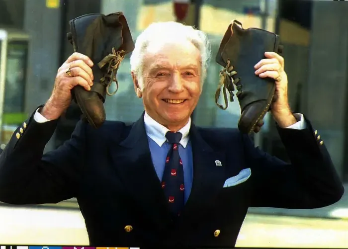 Framed Print : Football legend Sir Stanley Matthews holds up a pair of old fashion football boots in Framed Print : Football legend Sir Stanley Matthews holds up a pair of old fashion football boots in