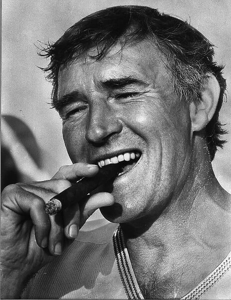 Football manager Malcolm Allison smoking a cigar. Circa 1975
