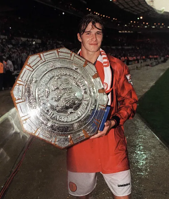 Framed Print : Football - Manchester Uniteds David Beckham celebrates holding the Charity Shield Framed Print : Football - Manchester Uniteds David Beckham celebrates holding the Charity Shield