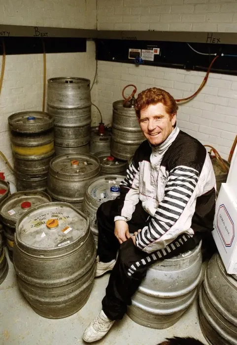 Framed Print : Football player and manager Alan Ball sitting on a barrell in the cellar of his new pub