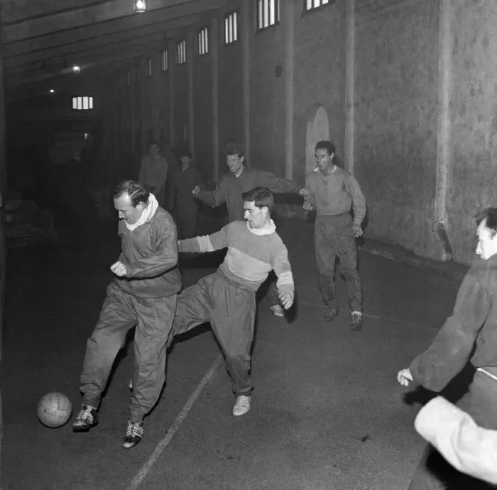 Framed Print : Football players train under one of the stands as snow prevents training at the Brittania