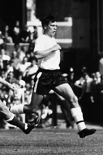 Footballer Bobby Robson running on the pitch