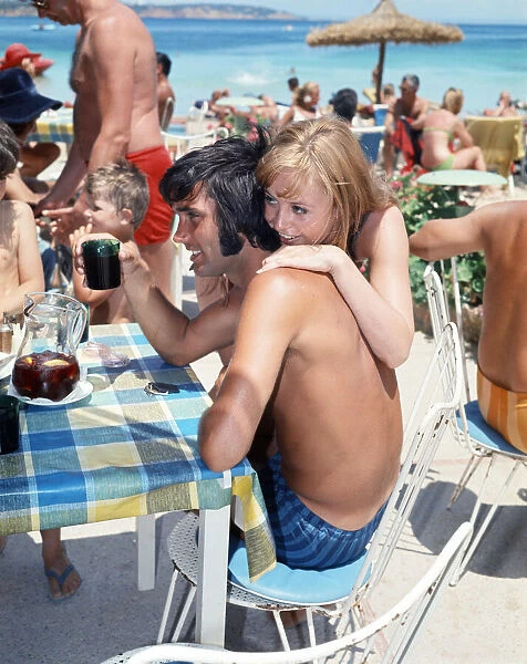 Footballer George Best with actress and model Susan George on holiday in Palmanova