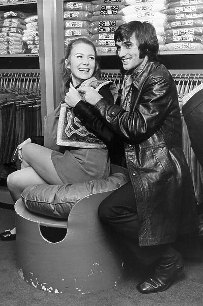Footballer George Best seen here with Juliet Mills at his boutique in Manchester