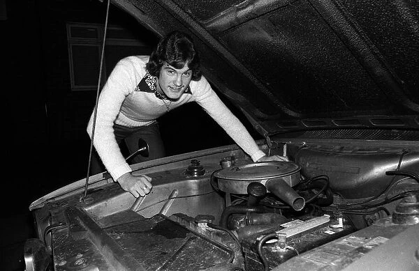 Footballer Glenn Hoddle at home with his car 1976