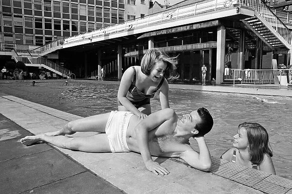 Footballer Johnny Byrne relaxing at oasis swimming baths. 21st August 1964