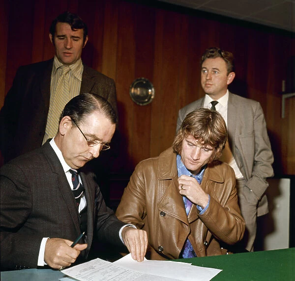 Footballer Rodney Marsh signs his contarct to join Manchester City Manager Malcolm