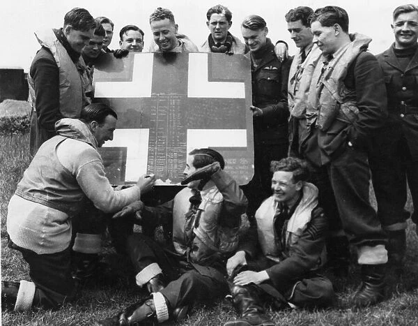 A fragment cut from an enemy aircraft which this RAF squadron shot down is used for