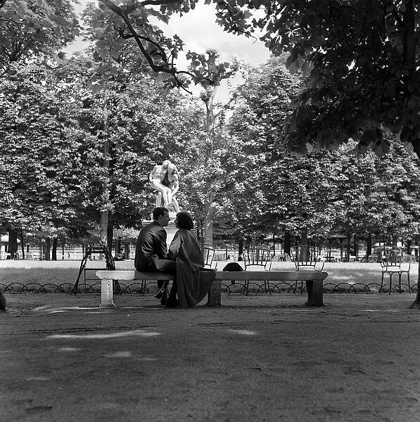 France Paris -lovers kiss in a park by a statue during the 1958 state of emergency