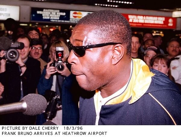 Frank Bruno addresses the press after arriving back at Heathrow airport after his defeat