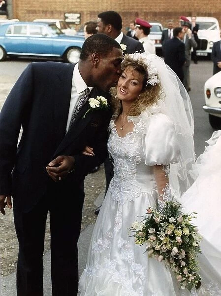 Frank Bruno Boxer gives his wife Laura a kiss after the ceremony