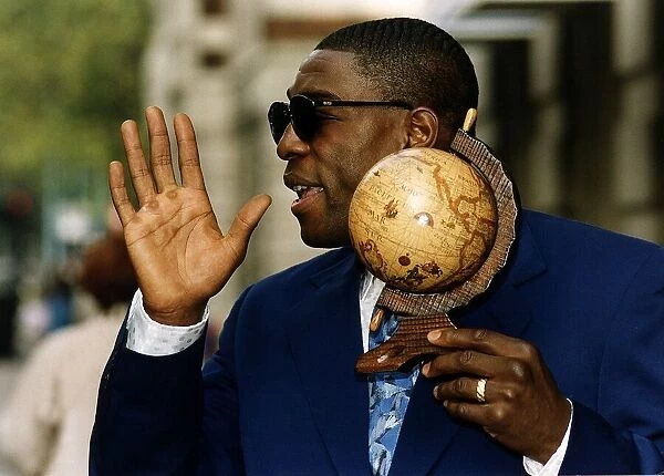 Frank Bruno Boxer holding a model of the world