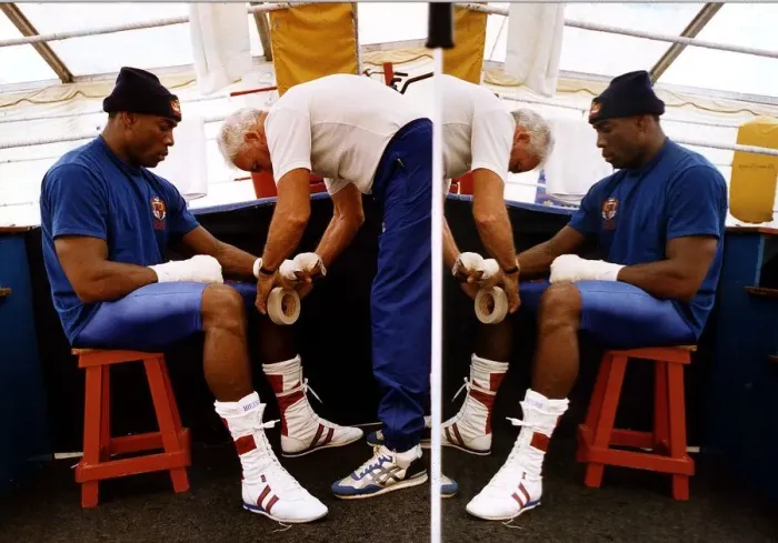 Framed Print : Frank Bruno Boxer sitting on stall having a bandage put on his hands