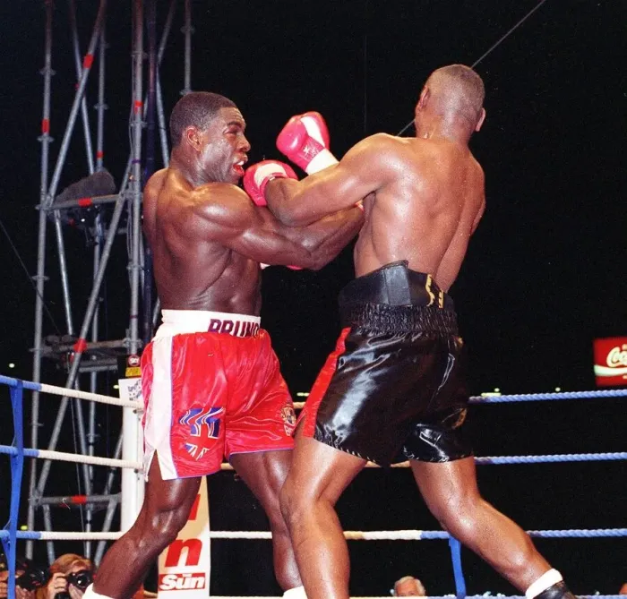 Framed Print : Frank Bruno lands another punch to the head of Oliver McCall in his WBC championship Framed Print : Frank Bruno lands another punch to the head of Oliver McCall in his WBC championship