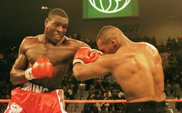 Framed Print : Frank Bruno lands a rare punch on Mike Tysons chin during the WBC world title fight in Framed Print : Frank Bruno lands a rare punch on Mike Tysons chin during the WBC world title fight in