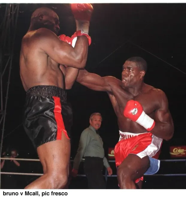 Framed Print : Frank Bruno strikes Oliver McCall with a right hook during their fight for Framed Print : Frank Bruno strikes Oliver McCall with a right hook during their fight for