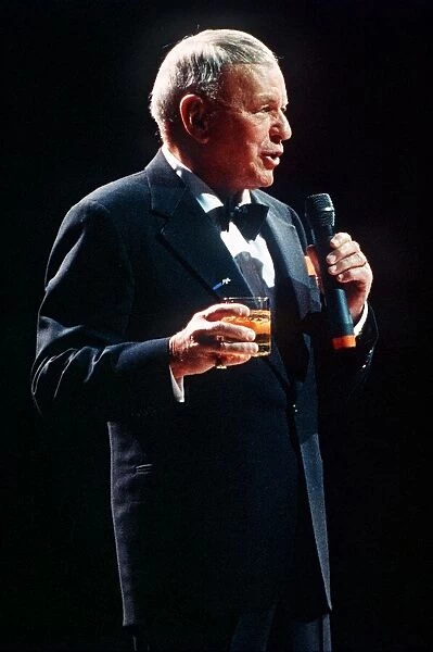 Frank Sinatra sings in concert with drink in hand circa 1990