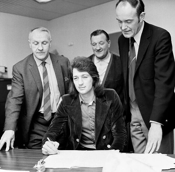 Frank Worthington signs for Liverpool from Huddersfield Town at Anfield watched by