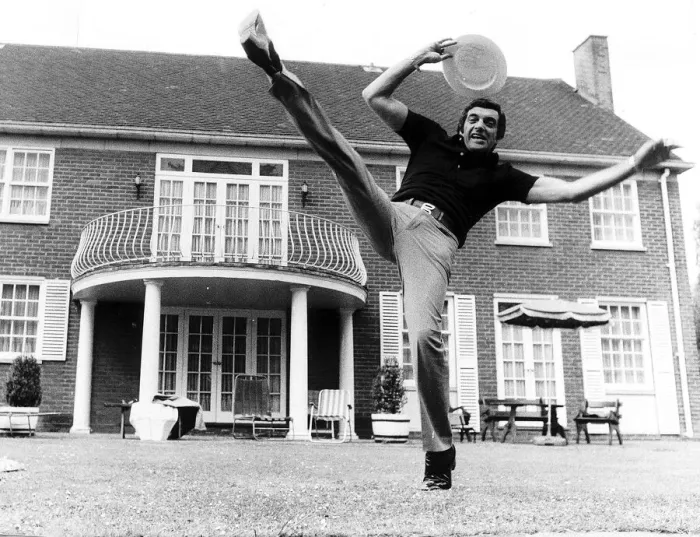 Framed Print : Frankie Vaughan singer does his high kick routine June 1974 holding his boater in