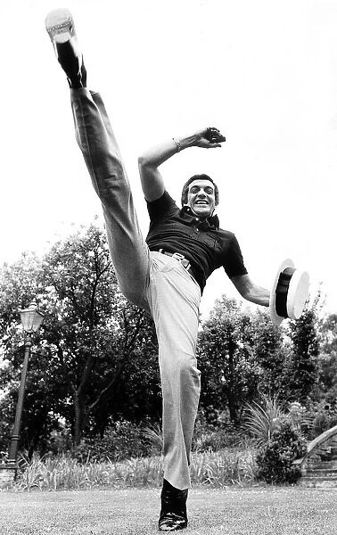 Frankie Vaughan singer and entertainer May 1974 kicking foot high up in air
