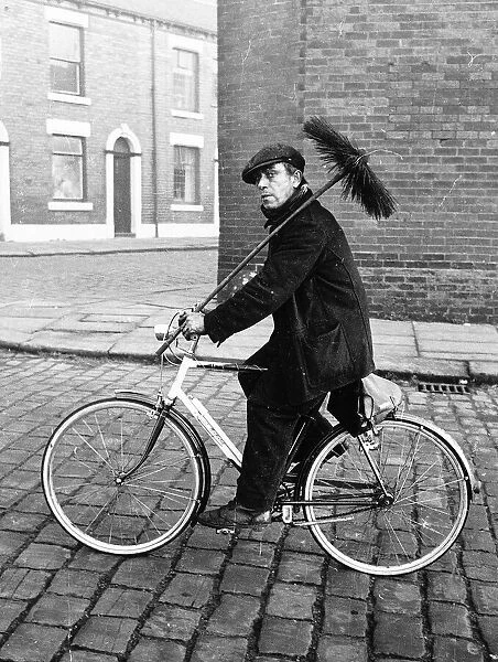 Fred Gibson chimney sweep riding bike on his round 1965 in Chadderton Lancs