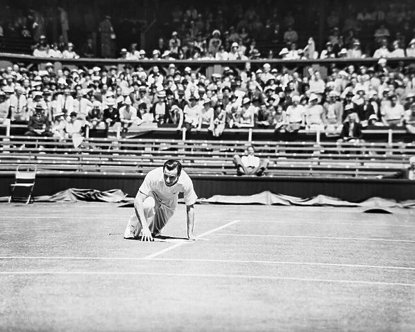Fred Perry falls yet smiles on the court at The Wimbledon Mens Tennis Championships 1935