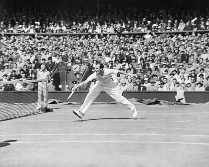 Framed Print : Fred Perry (GB) plays a back hand shot at the net, competing at Wimbledon Tennis in