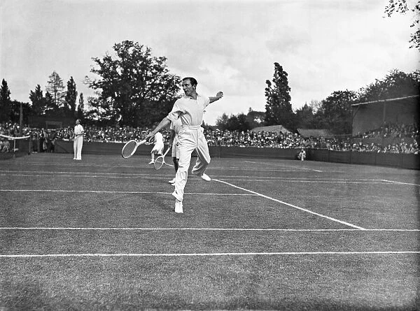 Fred Perry playing doubles lawn tennis. It is not clear as to the actual