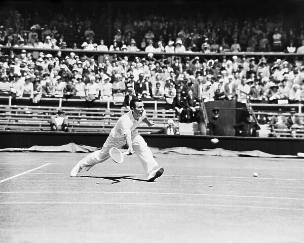 Fred Perry playing a low forehand shot at The Wimbledon Mens Tennis Championships 1935