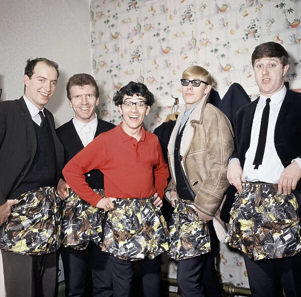 Freddie and the Dreamers pop group pose with swimming trunks presented to them by their