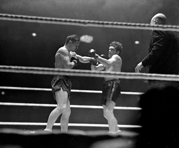 Freddie Mills (right) takes a left from Bruce Woodcock in their heavyweight fight