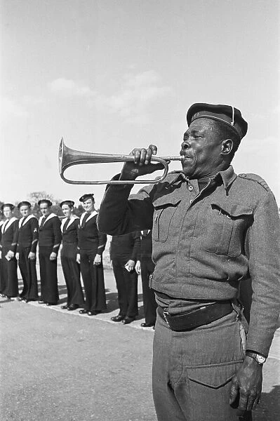Free French sailors are call to parade by a bugler at their barracks in Southern England