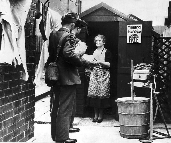 Free washing for the troops - a laundry woman hands over the soldiers