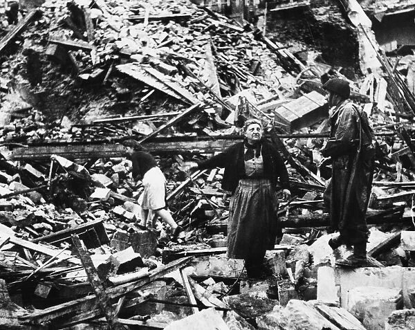 French civilians search through bombed ruins during Second World War somewhere in France