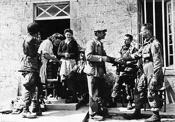 French civilians welcome American paratroopers, members of the Allied Expeditionary Force