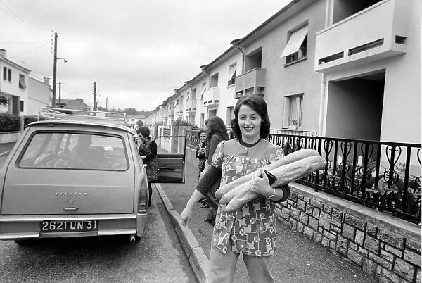 French housewife Mrs. Maria Quaranta after buying the days bread from the delivery car