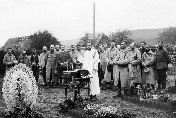French soldiers hold a mass amongst the graves of their fallen comrades just behind