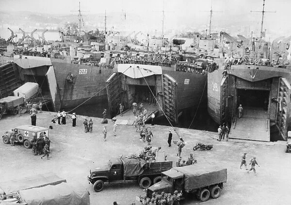 French vehicles and troops disembarking at an Italian port. 10th January 1944