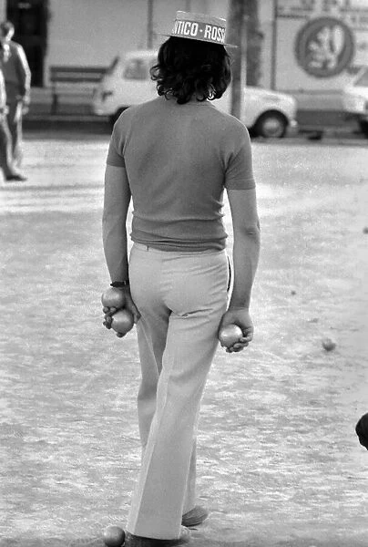 Frenchmen play Boules in the streets of Poussan, France. April 1975 75-2097-011