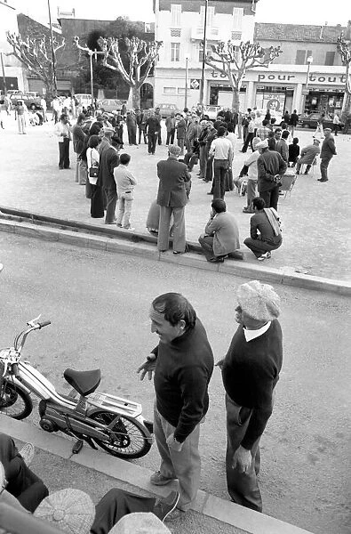 Frenchmen play Boules in the streets of Poussan, France. April 1975 75-2097-013
