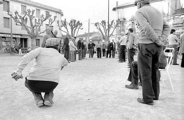 Frenchmen play Boules in the streets of Poussan, France. April 1975 75-2097-009