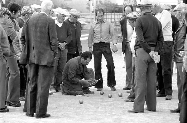 Frenchmen play Boules in the streets of Poussan, France. April 1975 75-2097