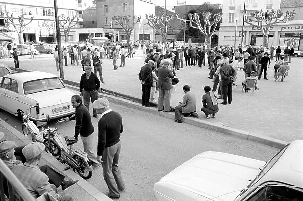 Frenchmen play Boules in the streets of Poussan, France. April 1975 75-2097-014