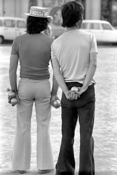 Frenchmen play Boules in the streets of Poussan, France. April 1975 75-2097-010