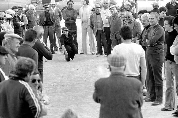 Frenchmen play Boules in the streets of Poussan, France. April 1975 75-2097-012