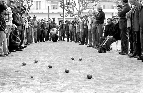 Frenchmen play Boules in the streets of Poussan, France. April 1975 75-2097-002